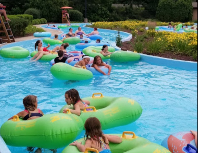 Family floating the lazy river on tubes